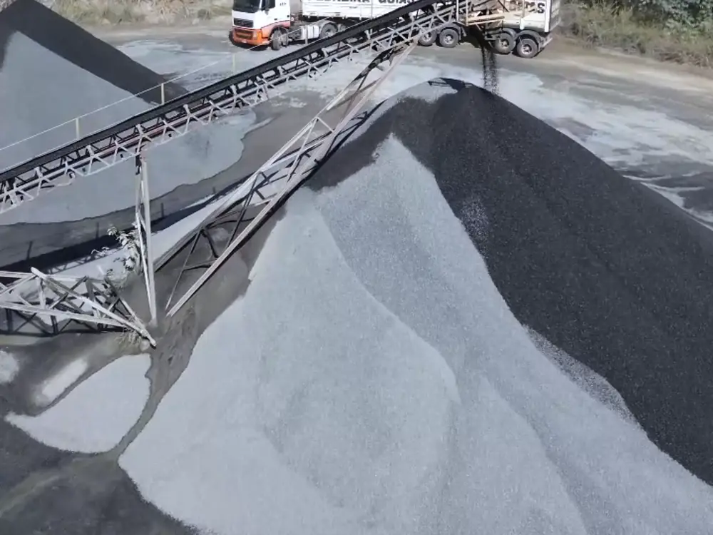 Pilha de areia de brita ao lado da correia transportadora, no pátio da Pedreira Goiás